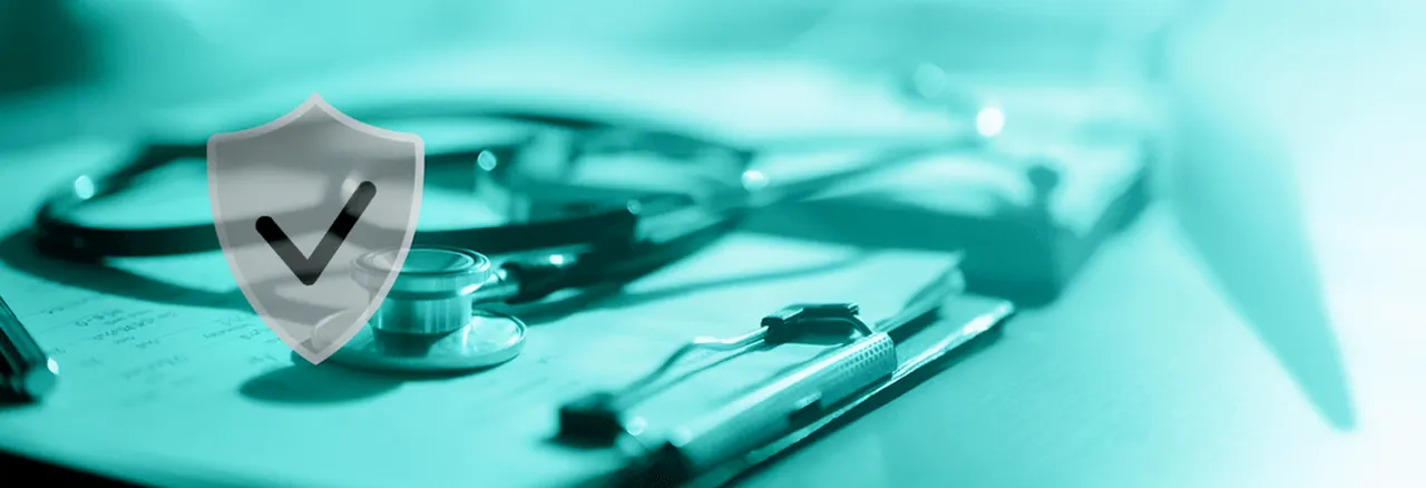 A stethoscope resting on a clipboard beside a shield with a check mark.